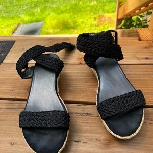 Stuart Weitzman platform woven sandals with open toe and ankle strap.